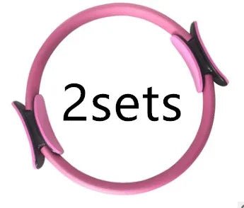 Pink Pilates ring with black grips, 2 sets for elegant home workouts