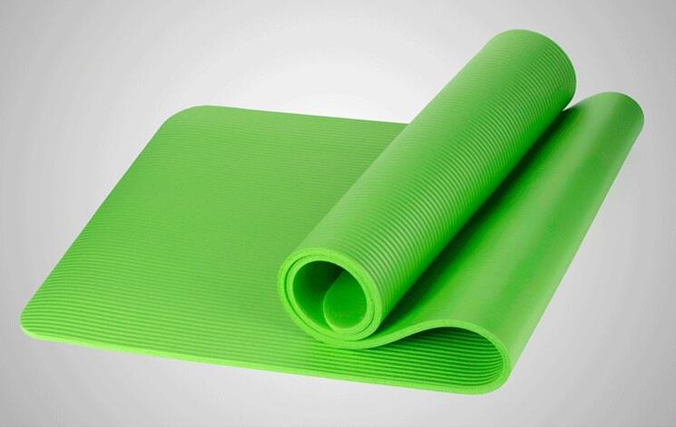 Vibrant green yoga mat with textured grip, partially rolled for elegant home practice