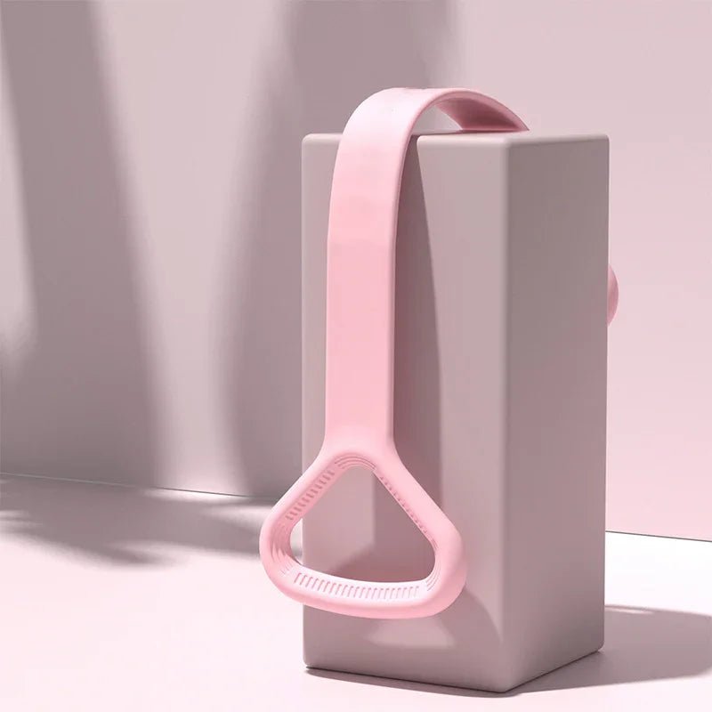 Elegant pink resistance band draped over a minimalist block, blending faith-inspired wellness with modern design.