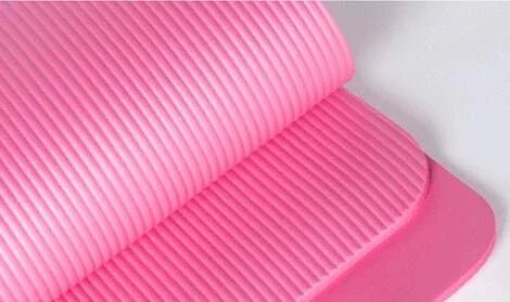 Soft pink ribbed yoga mat, elegant and faith-inspired design for serene practice.